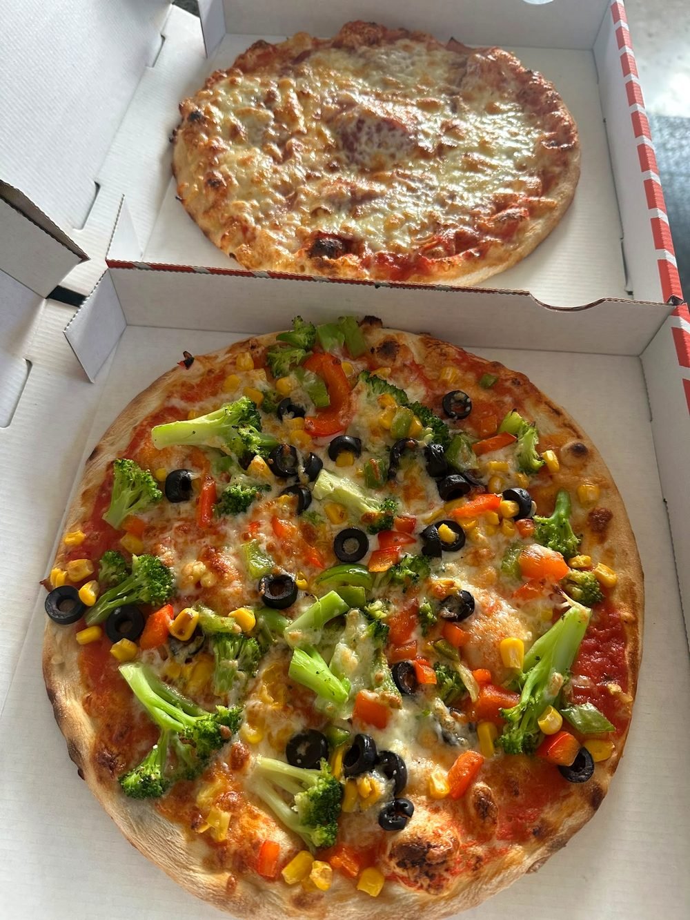 Bunte vegetarische Pizza mit Paprika, Mais, Brokkoli und Oliven